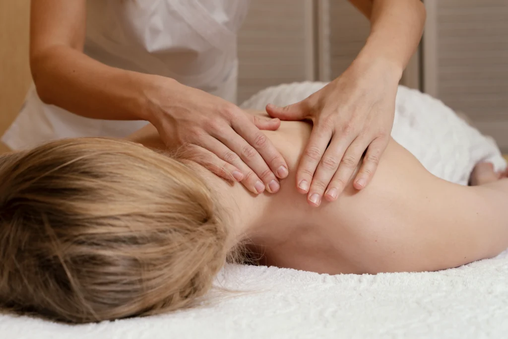 Massage therapist working on a client's back muscles