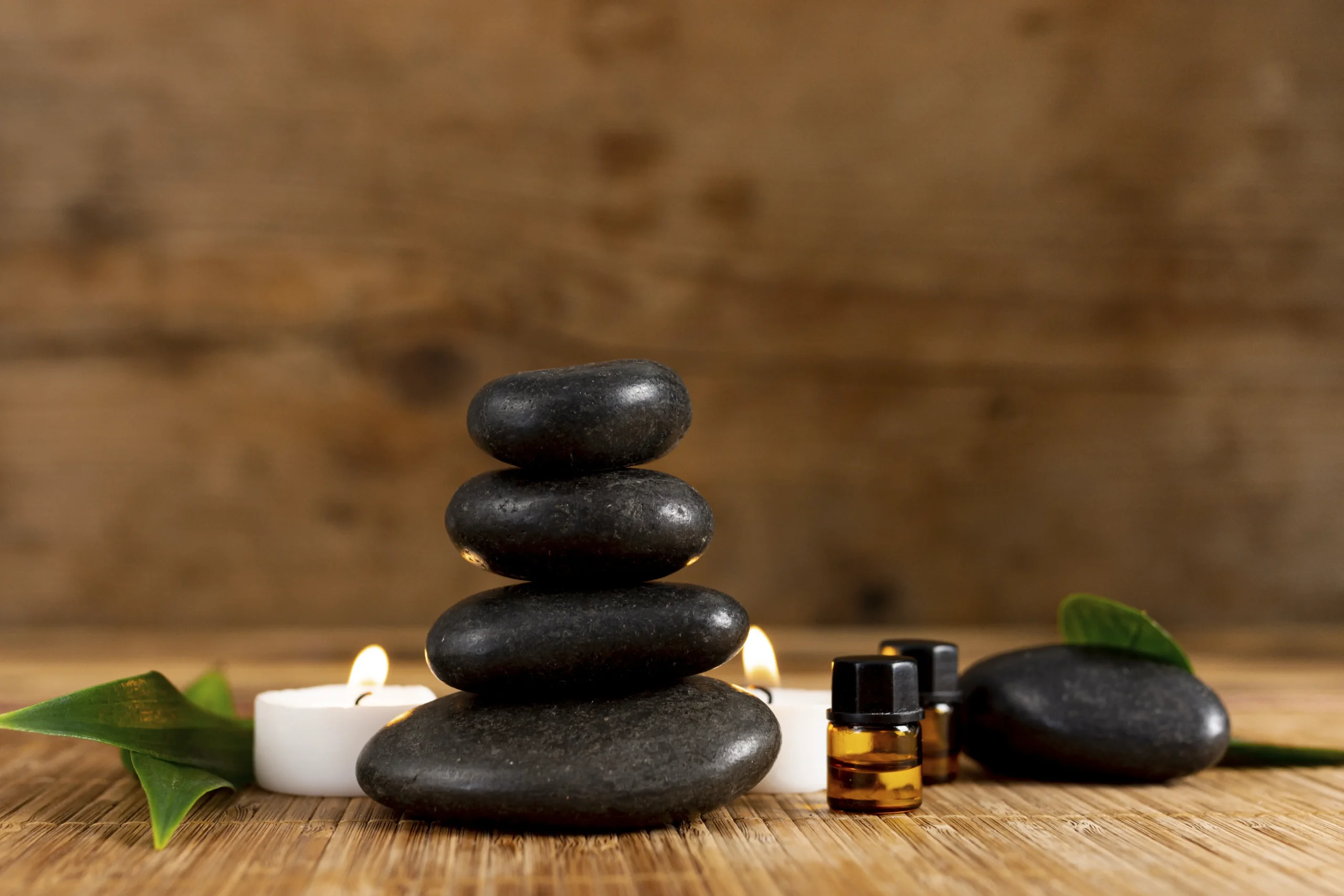 Hot stone massage arrangement with basalt stones and candle